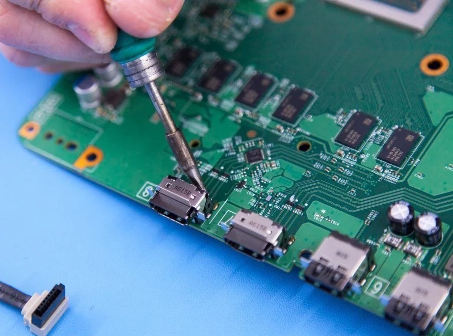 Technician micro-soldering PS5 HDMI port repair Tacoma WA